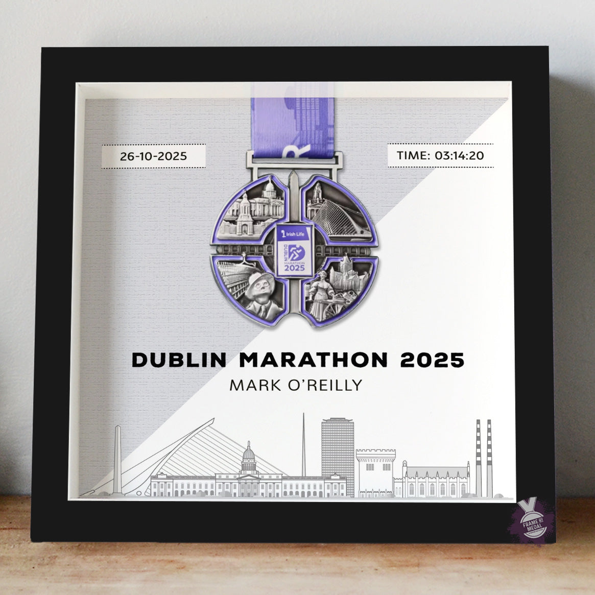 Framed Dublin Marathon 2025 medal display with a black frame and grey background